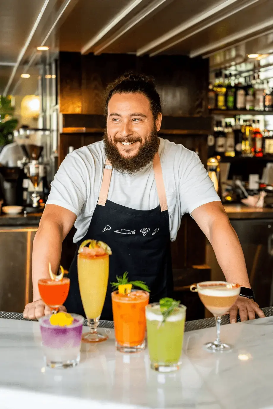 Bartender with cocktails on the counter top
